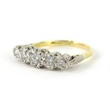 An 18ct gold five stone diamond ring, the five graduated illusion set diamonds, on a part pierced