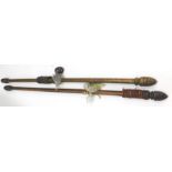 A pair of Victorian mahogany curtain poles, with carved acorn tops, with rings and other fittings,