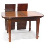 An early 20thC mahogany draw leaf dining table, the rounded top with a wide crossbanding, on