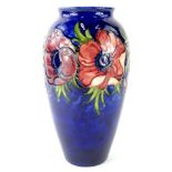 An early 20thC Moorcroft pottery Anenome pattern vase, of shouldered form on blue ground, Late Queen