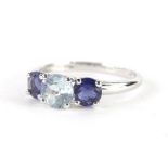 A 9ct white gold dress ring, set with blue and white stones, each in a claw setting, size O, 2g