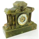 A 19thC green marble mantel clock of classical design, the shaped top centred by a Classical mask,