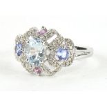 A ladies 9ct white gold dress ring, the pierced top claw set with an oval blue stone and set with