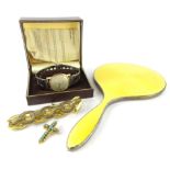 A George V silver and yellow enamel hand mirror, of shaped form, Birmingham 1929, 25cm wide, a