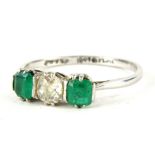 An emerald and diamond three stone ring, with central old cut diamond, measuring 4.8mm x 4.8mm x 2.