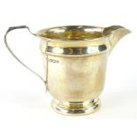 A George VI silver cream jug, by Edward Viner, the shaped body with plain spout and angular ear