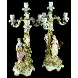 A pair of late 19thC Sitzendorf candelabra, each with four branches, decorated with flowers and