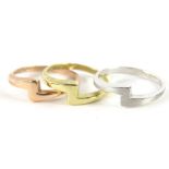 A set of three 9ct white, yellow and rose coloured gold rings, each of shaped form, size O, 5.1g all