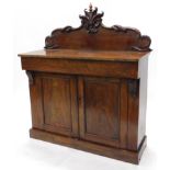 A Victorian mahogany chiffonier, the carved shaped top with a (replacement) finial, above a