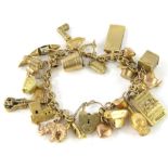 A 9ct gold charm bracelet, with heart shaped clasp and a mixture of gold yellow metal and plated
