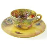A 20thC Royal Worcester cabinet cup and saucer, by James Skerrett, hand painted with brambles and