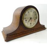An early 20thC oak cased Napoleon hat mantel clock, the shaped case on compressed orb feet, with a