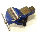 A large table vice, partially painted blue, 21cm high, 45cm deep.