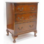 A 20thC walnut chest of three cockbeaded drawers, each with swan neck handles, the top with a wide
