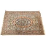 A 20thC Persian Kerman style rug, of rectangular form with a central oval medallion, set with