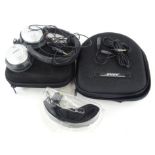 A Bose Quiet Comfort 2 Acoustic noise cancelling headphone set, in outer case and another with