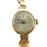 A 9ct gold ladies Accurist wristwatch, with small circular watch head, with circular fan type link