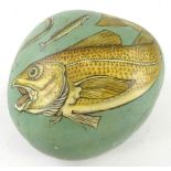 A painted rock decorated with pike and eel, on blue ground, 16cm wide.