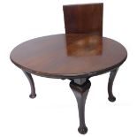 An early 20thC walnut extending dining table, the oval top with a moulded edge on cabriole legs with