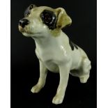 A Winstanley pottery figure of a standing dog, with glass eyes, black and white coat, marked