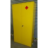 An industrial type metal locker in yellow, with highly flammable label, with spring handle and