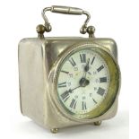 An early 20thC silver plated cased travel clock, with circular glass front in a square case with