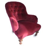 A Victorian walnut armchair, upholstered in red button fabric with a padded back, arms and