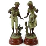 After Bruchon. A pair of early 20thC spelter figures of a boy and girl, each in flowing robes, aside