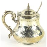 A Victorian silver mustard pot, with domed lid, 'S' scroll handle and bellied body, bright cut
