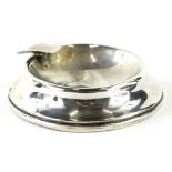 A 20thC silver ashtray, of circular form, with pipe rest, marks badly worn, 8cm wide, 6oz all in (