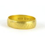 A 22ct gold wedding band, of textured form, size T, 4.5g.