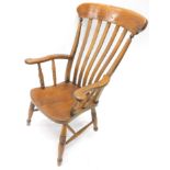 A late 19thC ash and elm grandfather chair, with carved cresting rail, vertical lath back, shaped