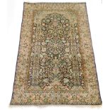 A Persian Tabriz style prayer rug, of rectangular form with central vase and flower flanked by