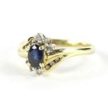 A ladies dress ring, claw set with a central blue stone, set with six small diamonds with six