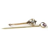 Two Victorian stick pins, comprising an aquamarine and seed pearl set pin, with scroll design top,
