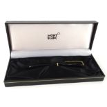 A Mont Blanc fountain pen, in black with gilt trim and clip, with white star to the lid, 12cm