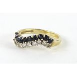 A ladies dress ring, shaped with small black stones and diamonds, size M, 2.5g all in.