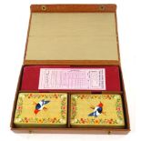 A cased set of Asprey London Grafton Bridge cards, in a fitted case with bird design to the back
