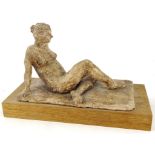 Ann Neimer (20thC). Reclining nude, clay sculpture, on wooden base, attributed beneath, 15cm high,