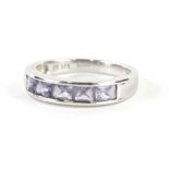 A 9ct white gold dress ring, with baguette cut purple stones, size O, 3.2g all in.