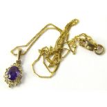 A 9ct gold amethyst pendant and chain, the pendant with central amethyst in floral scroll design