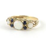 A 9ct gold dress ring, set with opals and small blue stones, on a part pierced shank, size K, 1.4g