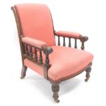 A late 19thC mahogany library armchair, with scroll overstuffed back and arms and T shaped seat,