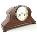 An early 20thC burr walnut and mahogany mantel clock, the shaped case with a wide crossbanding on