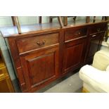 A hardwood dresser base, with a moulded and cleted top, above three frieze drawers and three panel