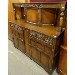 A 20thC oak court cupboard, with central cupboard raised above two frieze drawers and double