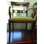 An early 19thC mahogany carver chair, with a bar back scroll, shaped arms and drop in seat with