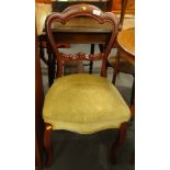 A Victorian walnut balloon back chair, with a padded seat on cabriole legs.