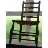 A 19thC ash ladder back side chair, with a rush seat on cabriole legs, 90cm high.