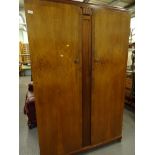 A mid 20thC walnut bedroom suite, comprising double door wardrobe, with moulded centre and shaped